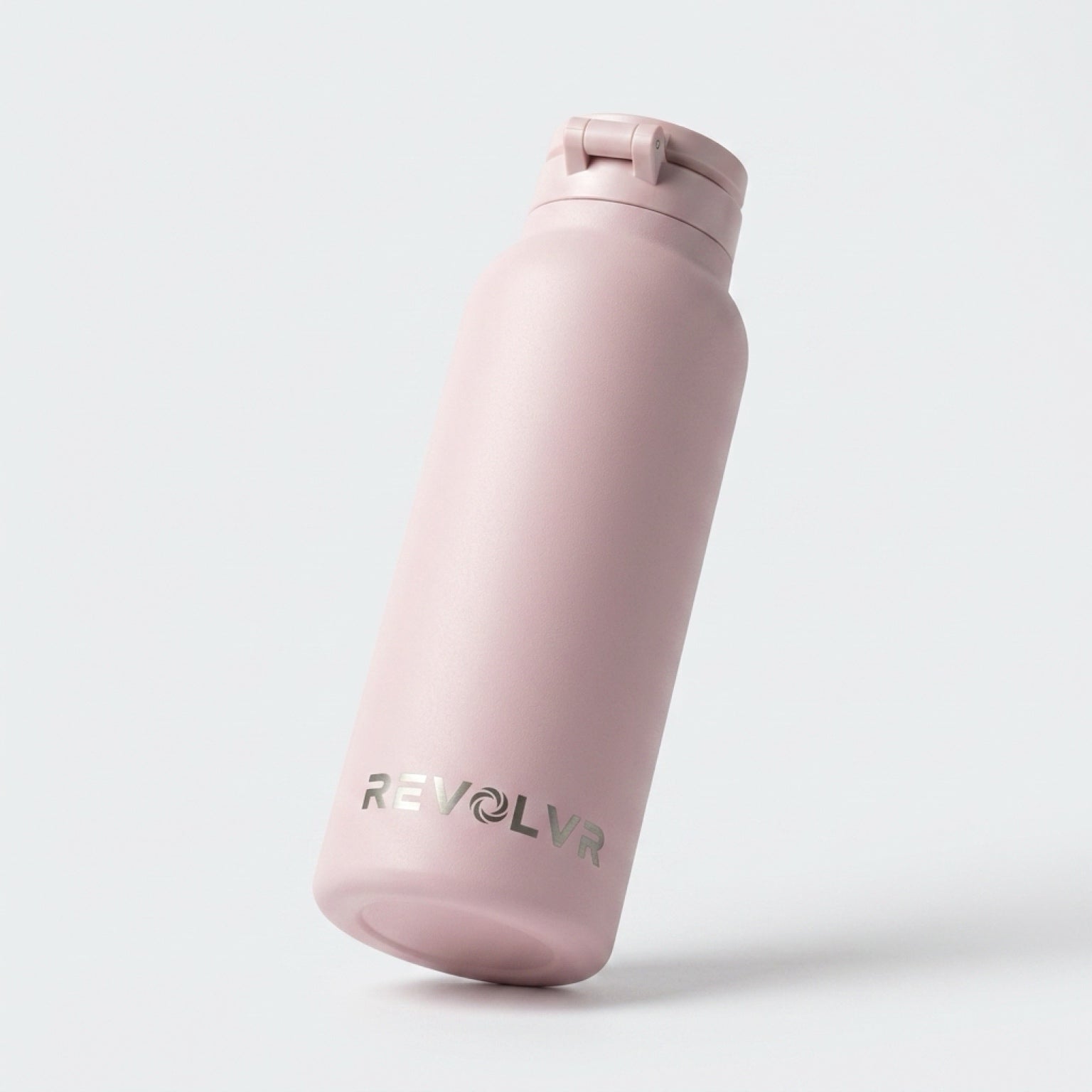 Pink water bottle with 'REVOLVR' branding on a light gray background